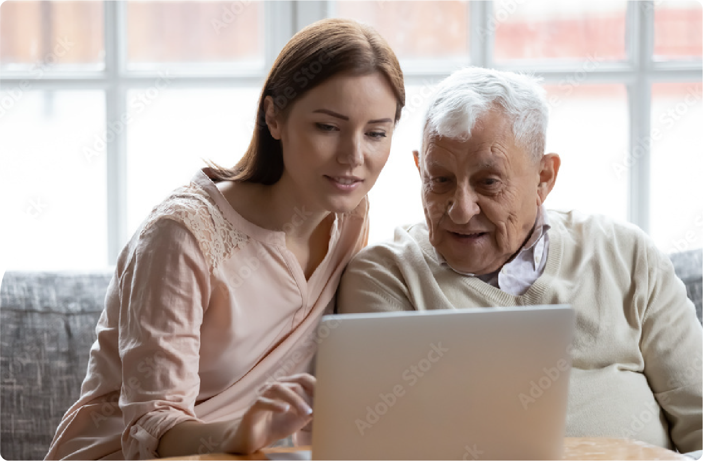 Photograph of a caucasian woman and older man looking at a computer learning about the FLU SV MRNA-002 Study.